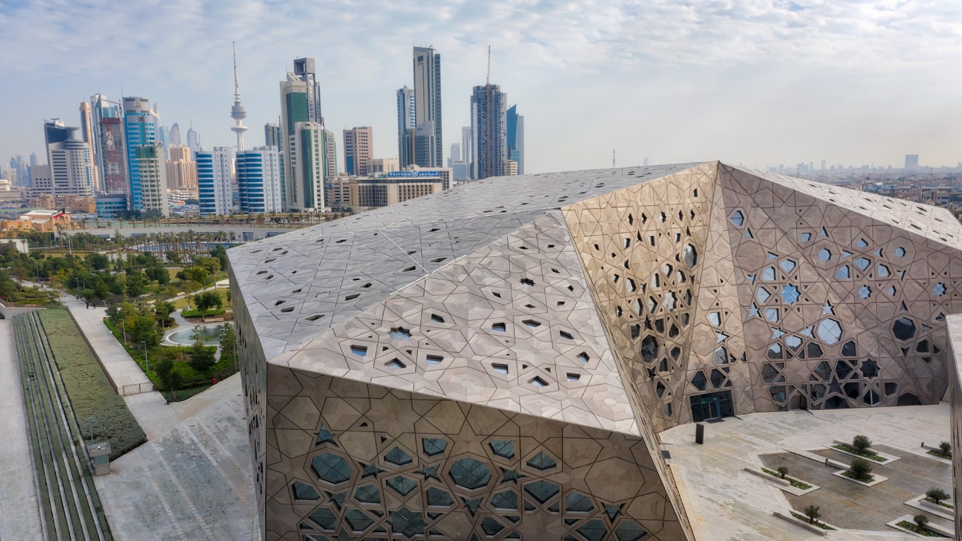 Image of the Sheikh Abdullah Al Salem Cultural Centre with the city skyline in the background.