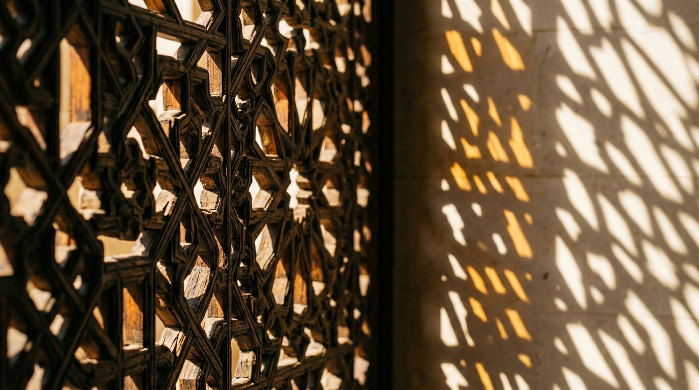AI Generated Image of a macro close-up of a traditional geometric mashrabiya screen with warm midday sunlight casting sharp shadow patterns across a pale stone wall